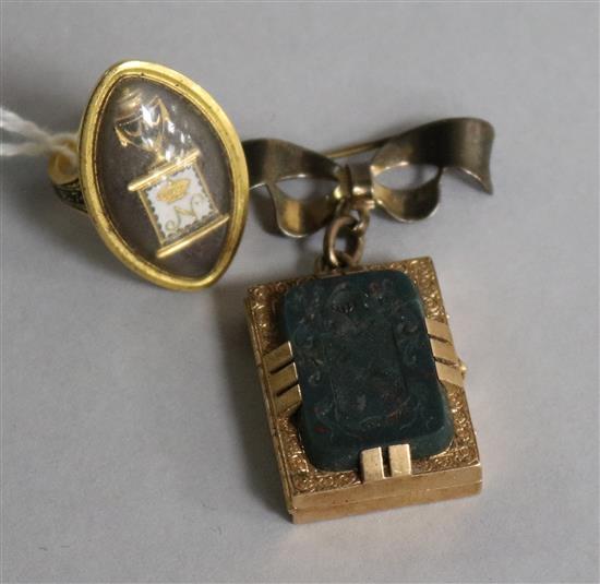 A yellow metal navette-shaped memorial ring, 1786 and a late 19th century rectangular locket inset intaglio-carved armorial bloodstone,